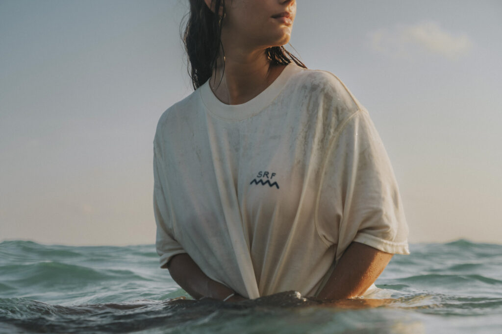 sri lanka - kobieta w oceanie na desce surfingowej